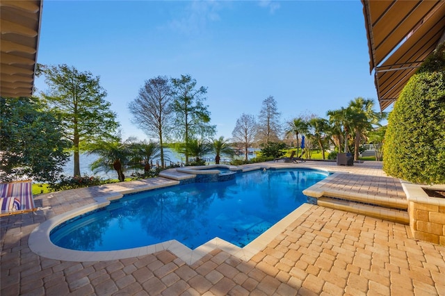 view of pool with a patio area and a pool with connected hot tub