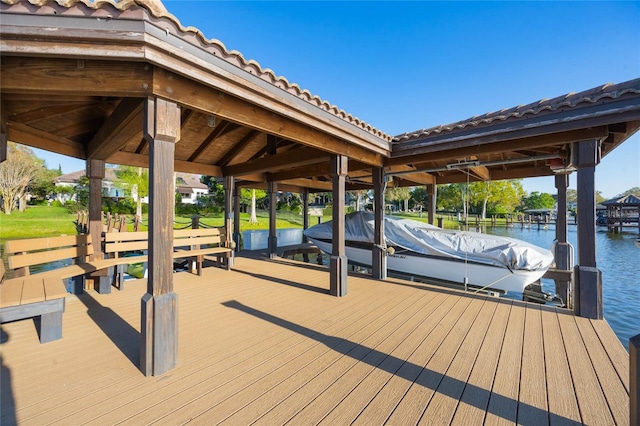 dock area with boat lift and a water view