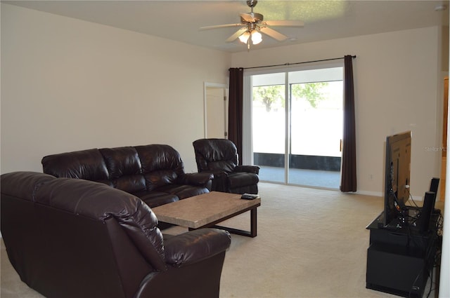 living area with light carpet and a ceiling fan