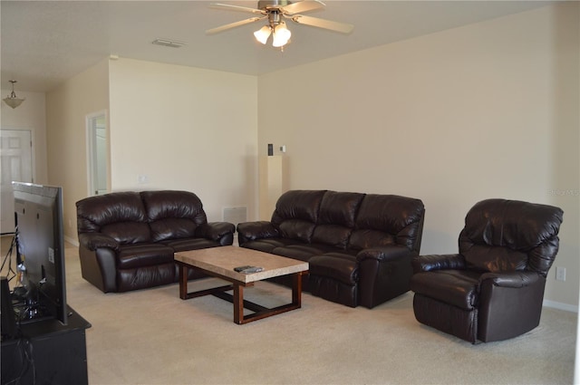 living room featuring visible vents, a ceiling fan, and light colored carpet