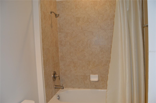 full bathroom with shower / tub combo and toilet