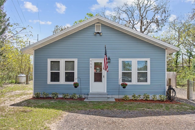 bungalow-style house featuring entry steps and fence