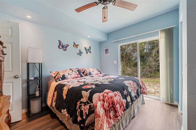 bedroom featuring access to exterior, ceiling fan, and wood finished floors