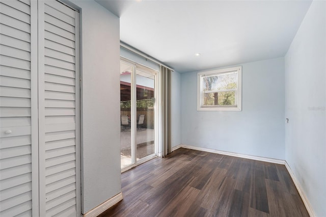 unfurnished room featuring dark wood finished floors and baseboards