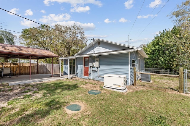 rear view of house with a lawn, a patio area, fence, and cooling unit