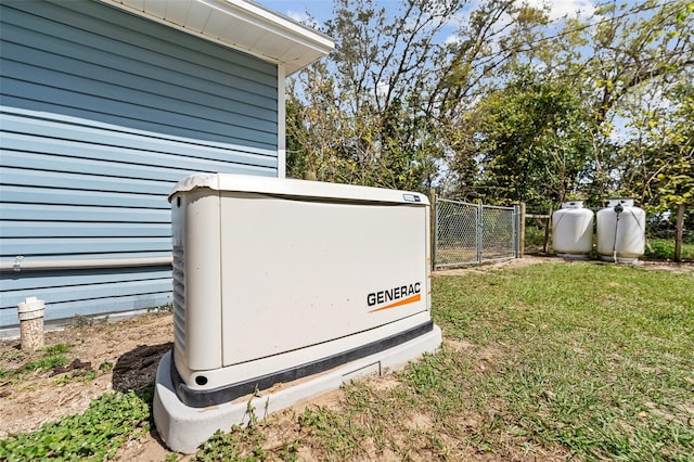 details featuring a power unit, fence, a gate, and heating fuel