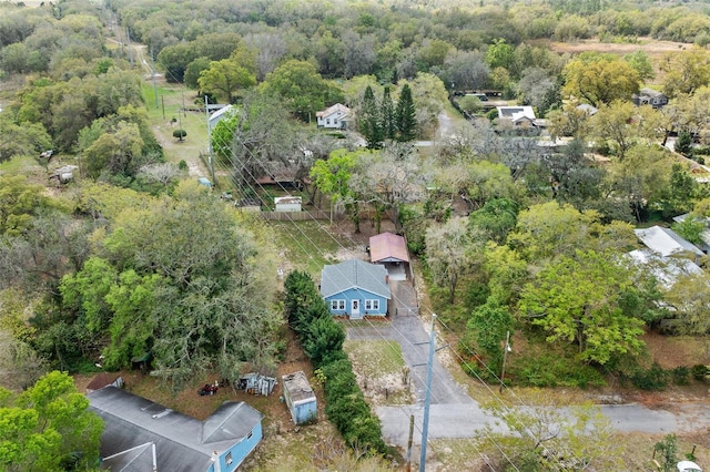 bird's eye view with a wooded view