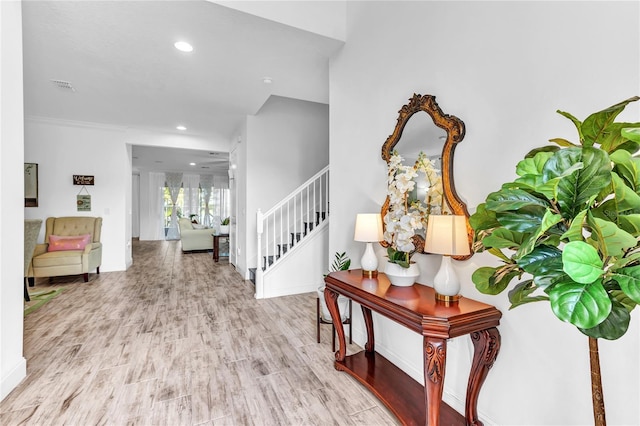 entrance foyer with recessed lighting, visible vents, wood finished floors, and stairs