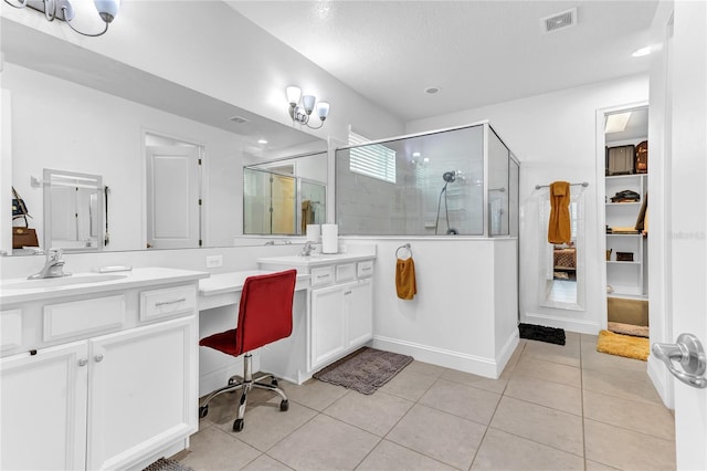 full bath featuring tile patterned flooring, a shower stall, vanity, and visible vents