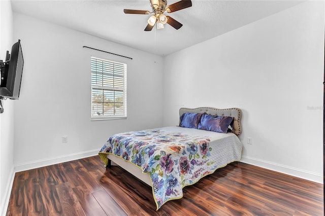 bedroom with baseboards, wood finished floors, and a ceiling fan