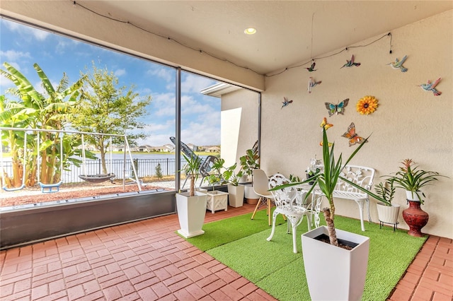 unfurnished sunroom with a water view