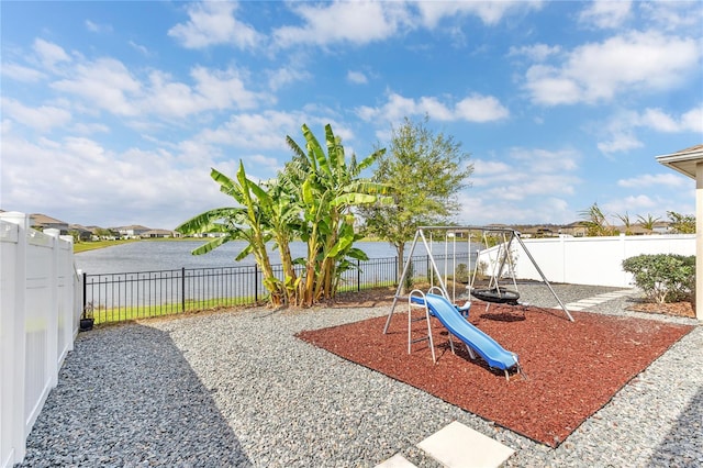 view of play area featuring a fenced backyard and a water view