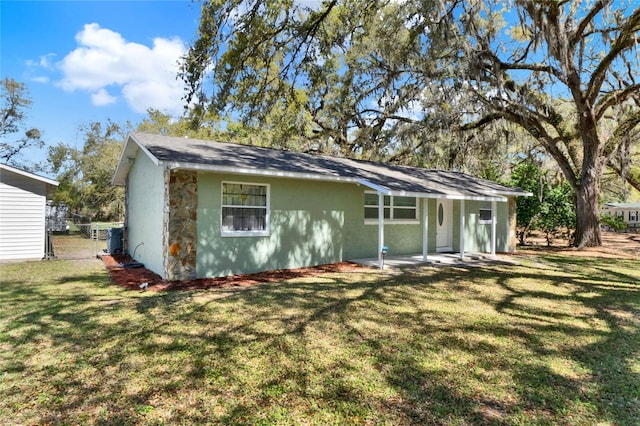 back of house with a gate, fence, and a lawn