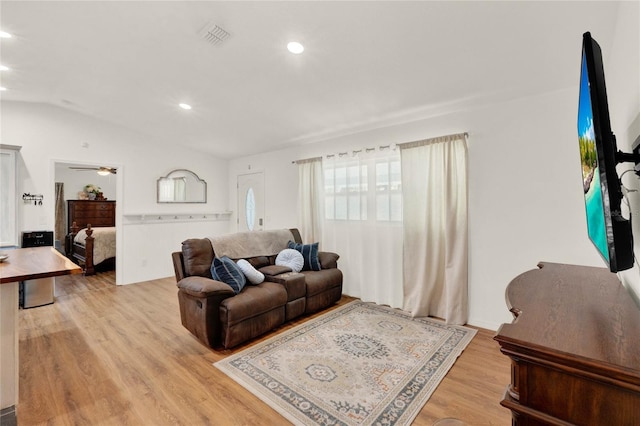 living room featuring lofted ceiling, recessed lighting, visible vents, light wood-style floors, and a ceiling fan