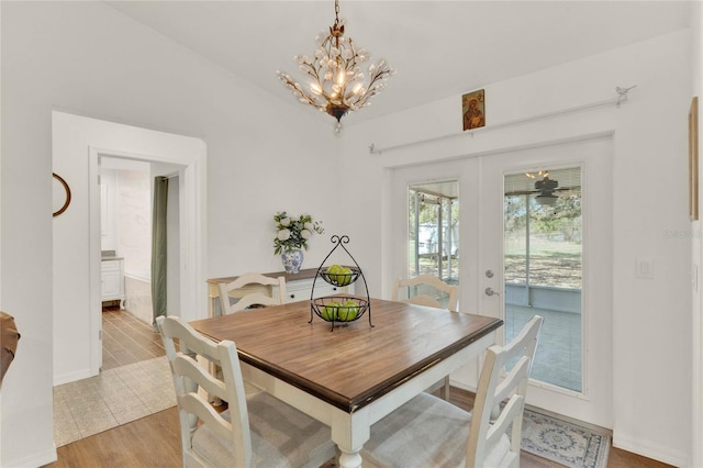 dining room featuring light wood-style flooring, a chandelier, and french doors