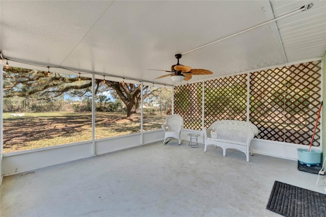 unfurnished sunroom with ceiling fan