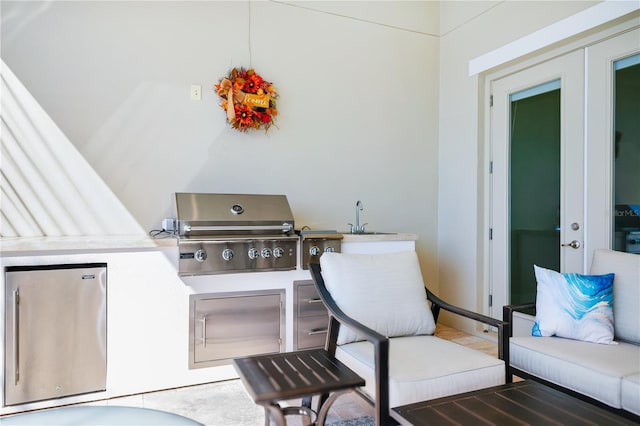 view of patio featuring french doors, a sink, and area for grilling