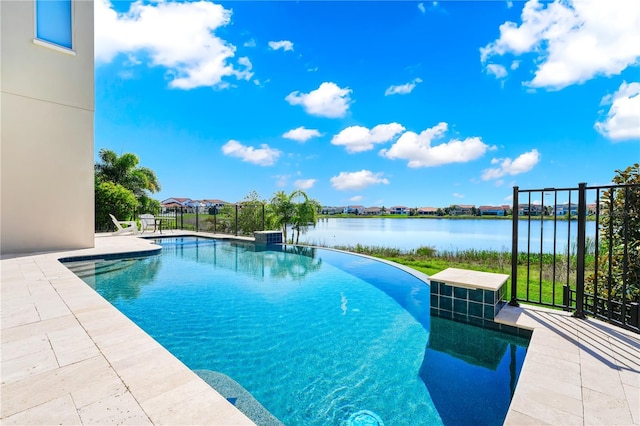 pool with a water view and a patio