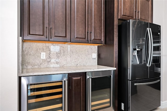 kitchen featuring dark brown cabinets, wine cooler, and stainless steel fridge