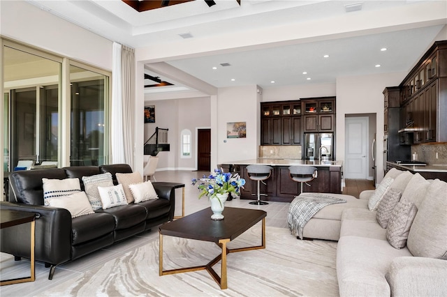 living area featuring recessed lighting, baseboards, and light tile patterned floors