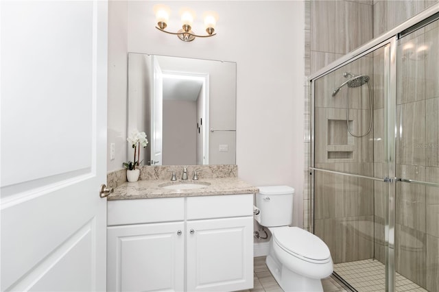 full bathroom featuring a stall shower, vanity, and toilet