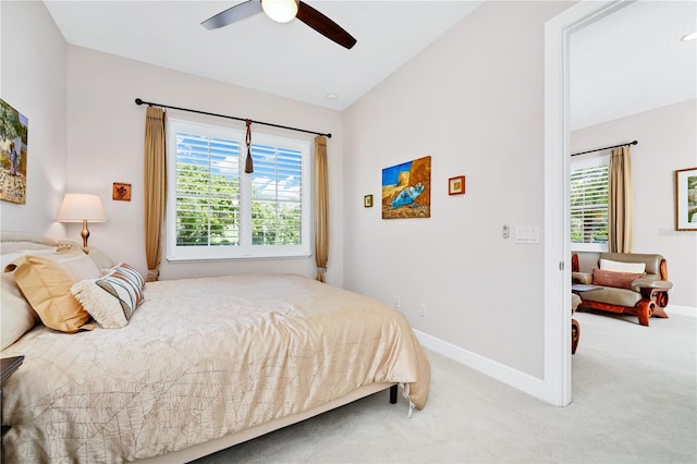 carpeted bedroom with ceiling fan, baseboards, and vaulted ceiling