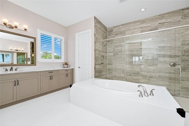 bathroom with a stall shower, a garden tub, and vanity