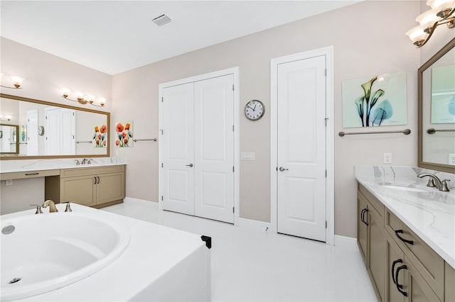 bathroom with two vanities, a sink, and visible vents