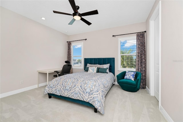 carpeted bedroom featuring ceiling fan and baseboards