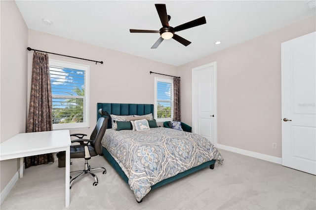 bedroom featuring a ceiling fan, light carpet, visible vents, and baseboards