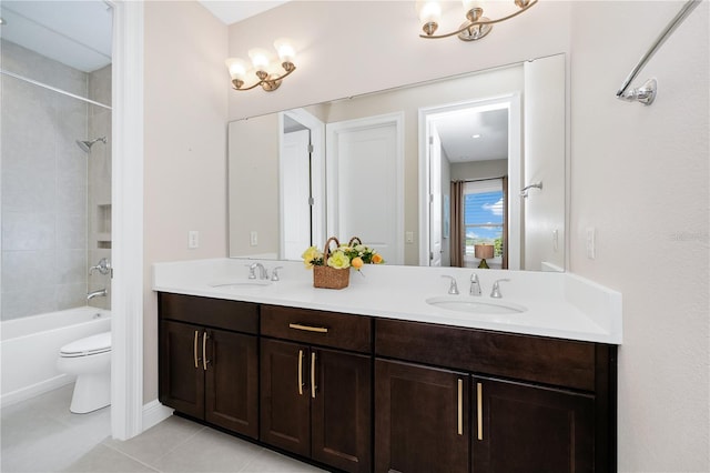 bathroom featuring tile patterned flooring, a sink, toilet, and double vanity