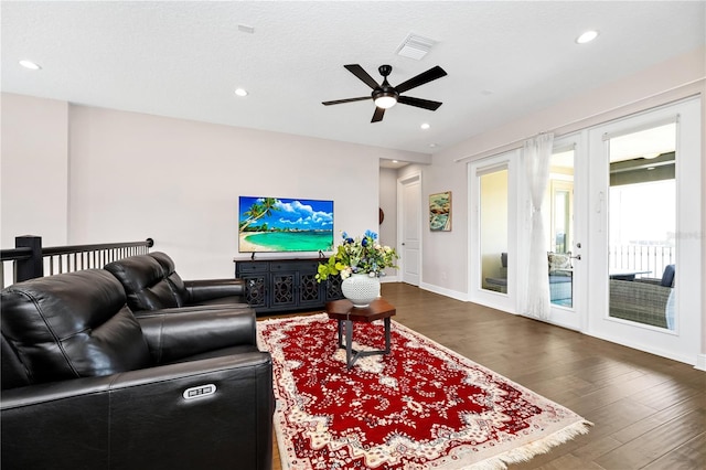 living room featuring baseboards, visible vents, dark wood-type flooring, french doors, and recessed lighting