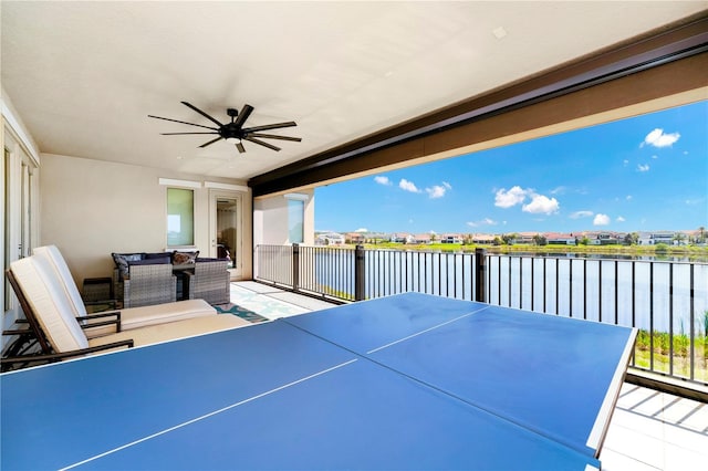 view of patio with an outdoor hangout area, a water view, a balcony, and a ceiling fan