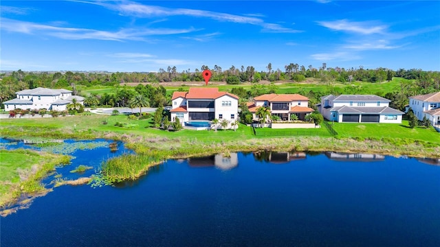 drone / aerial view featuring a residential view and a water view