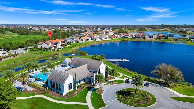 birds eye view of property with a water view and a residential view