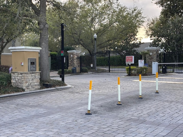 view of home's community featuring fence and a gate
