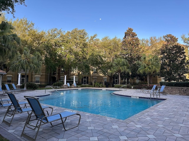 pool featuring a patio and fence