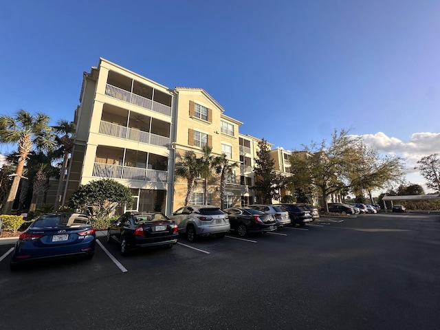view of building exterior with uncovered parking