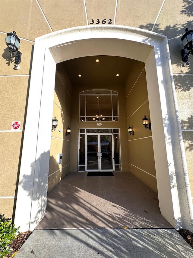 property entrance with french doors and stucco siding