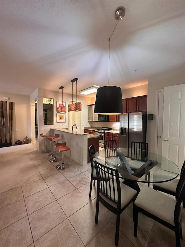 dining space featuring light tile patterned flooring