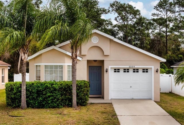 single story home featuring concrete driveway, an attached garage, fence, a front lawn, and stucco siding