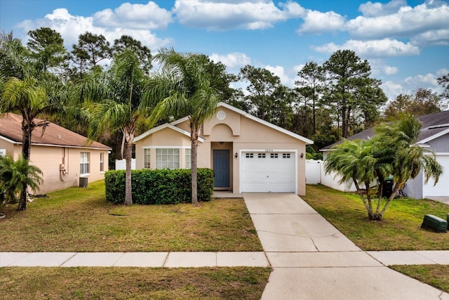 view of front of house featuring a garage, driveway, a front yard, and stucco siding