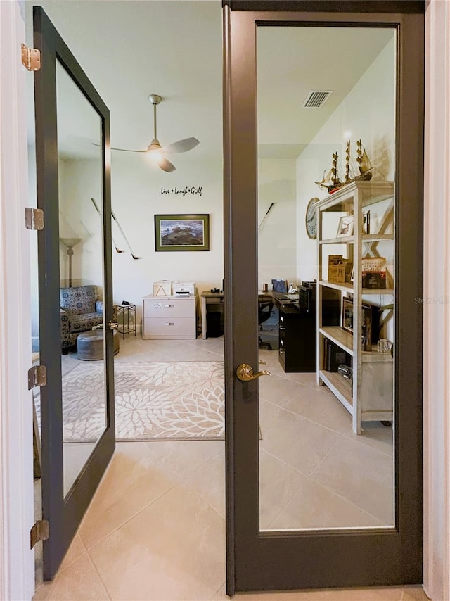 interior space featuring ceiling fan, french doors, tile patterned flooring, and visible vents