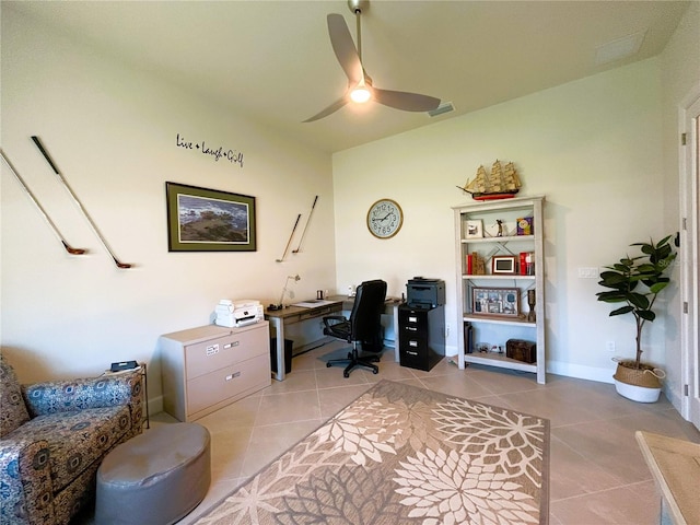 home office with light tile patterned flooring, ceiling fan, visible vents, and baseboards