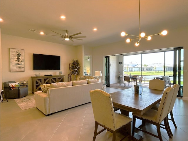 dining space with light tile patterned flooring, ceiling fan with notable chandelier, visible vents, and recessed lighting