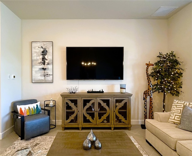 living area featuring baseboards, visible vents, and tile patterned floors