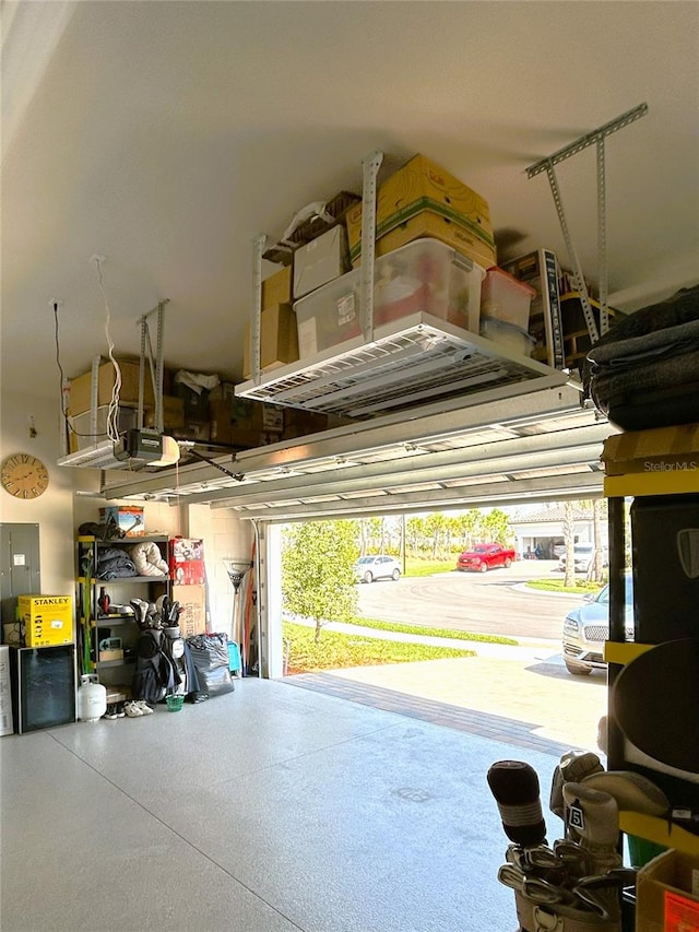 garage featuring a garage door opener and electric panel