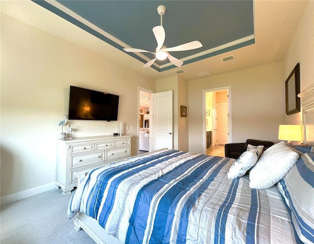 bedroom featuring light carpet, visible vents, baseboards, a raised ceiling, and a ceiling fan