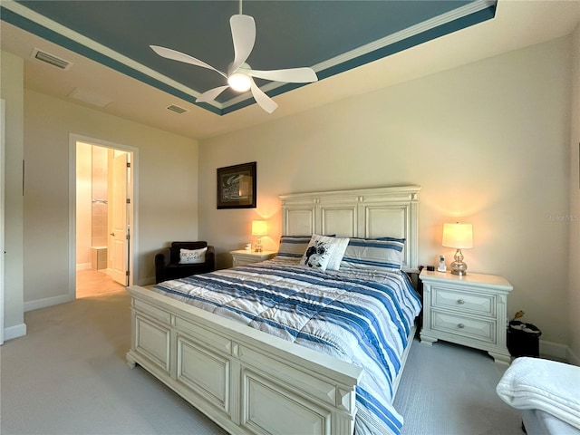 bedroom featuring a raised ceiling, visible vents, and baseboards