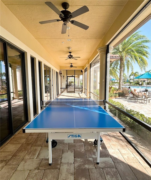 recreation room featuring stone tile flooring